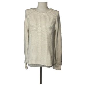 C. Wonder ivory crew neck sweater with rolled up cuffs.